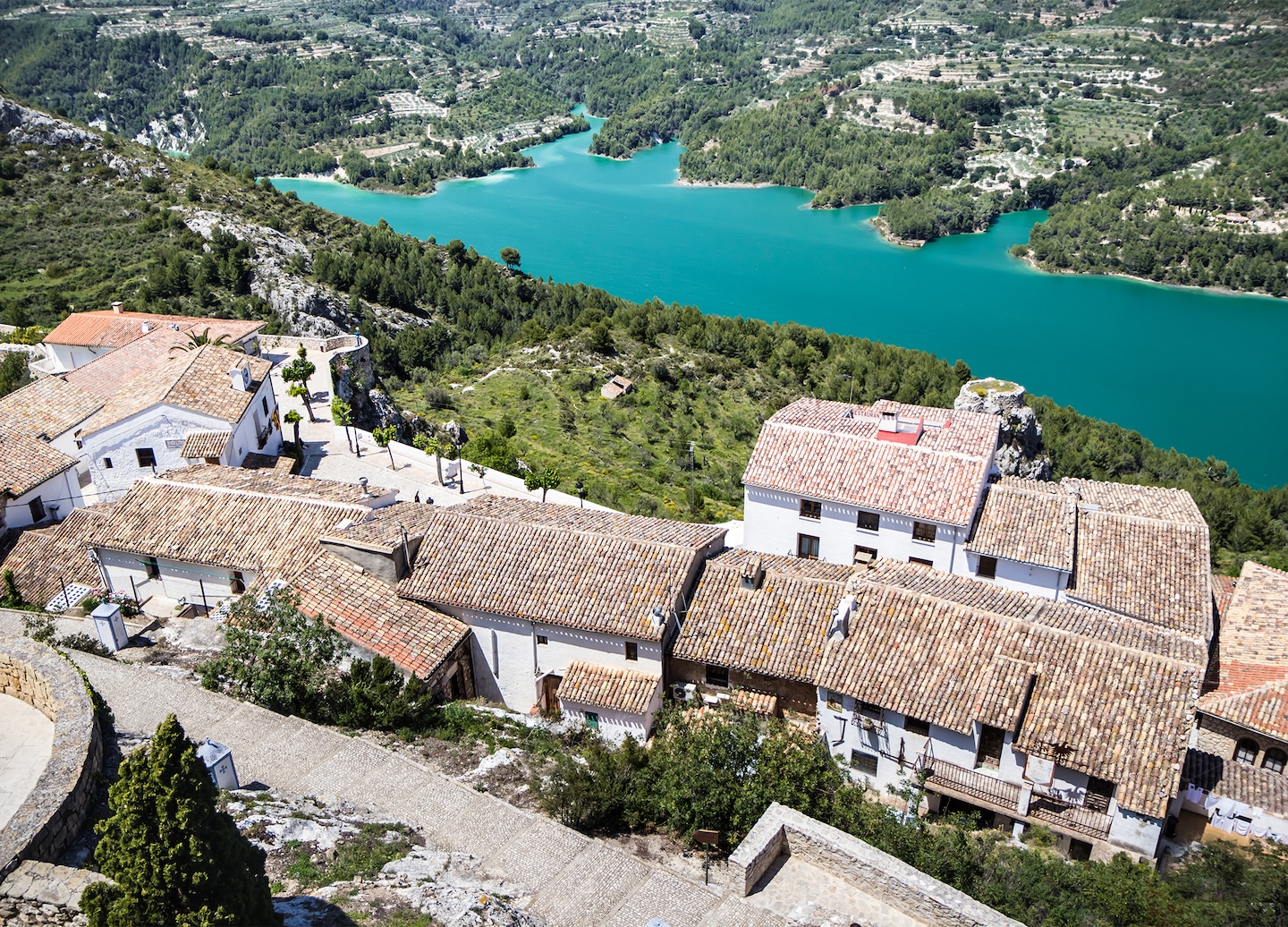 Guadalest’s cliffside village overlooks mountains, whitewashed homes, and cobblestone streets. - Alicante, Spain