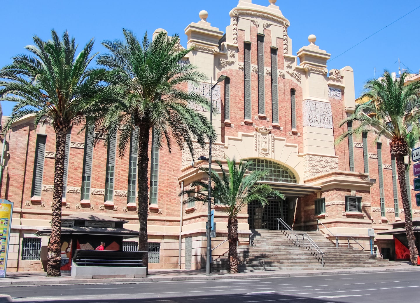 Central Market displays fresh produce and local goods beneath its historic brick façade. - Alicante, Spain