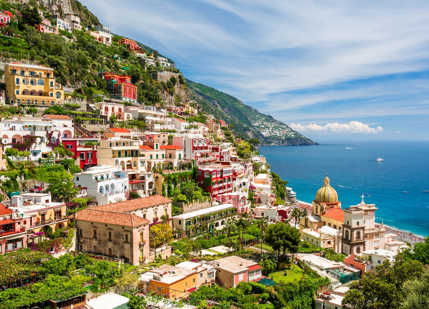 Positano’s cliffside homes overlook bright blue water along the steep Amalfi Coast. - Amalfi Coast, Italy