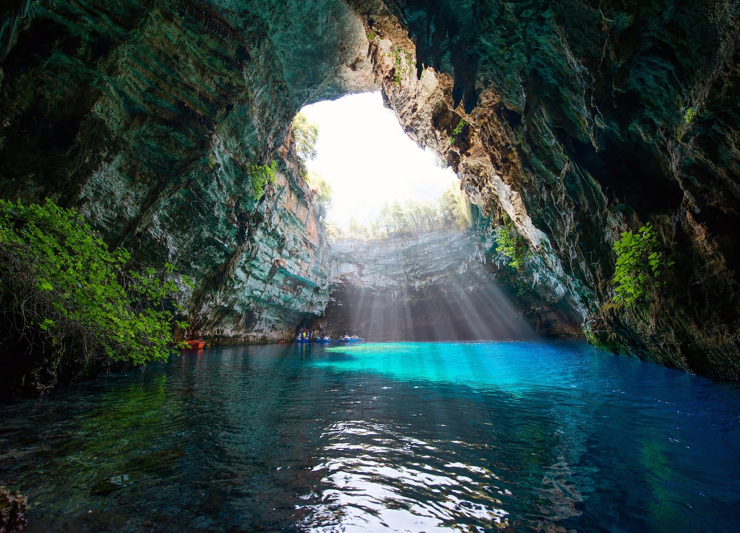 Visit Melissani Cave near Argostoli for glowing blue waters and nearby Drogarati Cave. - Argostoli, Greece