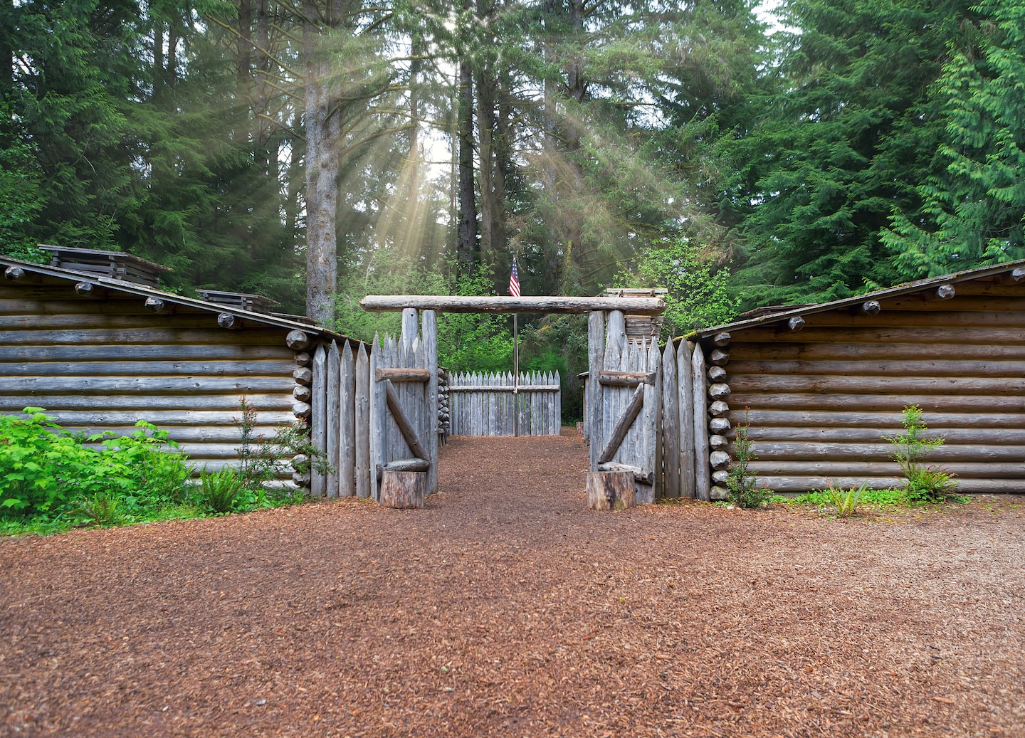 Wooden cabins stand quietly within the historic Fort Clatsop site. - Astoria, Oregon