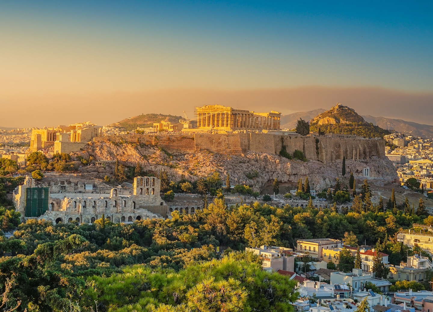 The Acropolis rises above Athens, with the Parthenon glowing softly against the hillside and sky. - Barcelona, Spain