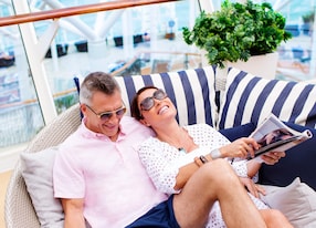 couple on lounge chair cabana on ship spending time together