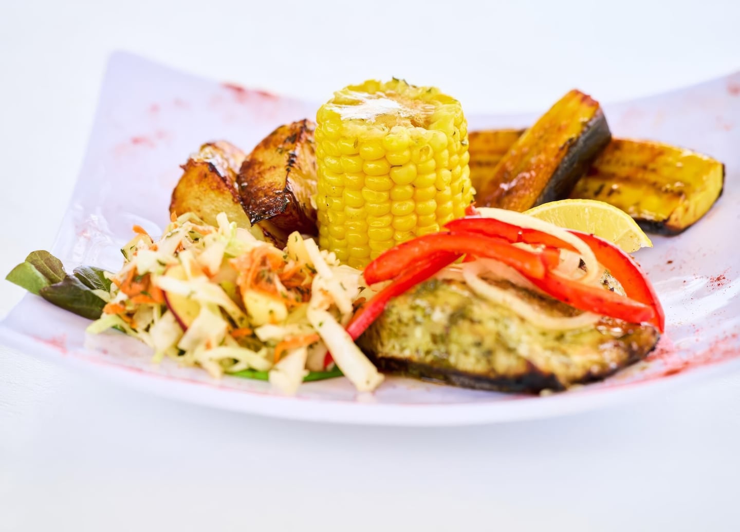 Grilled Caribbean fish served with fresh sides. - St. Kitts