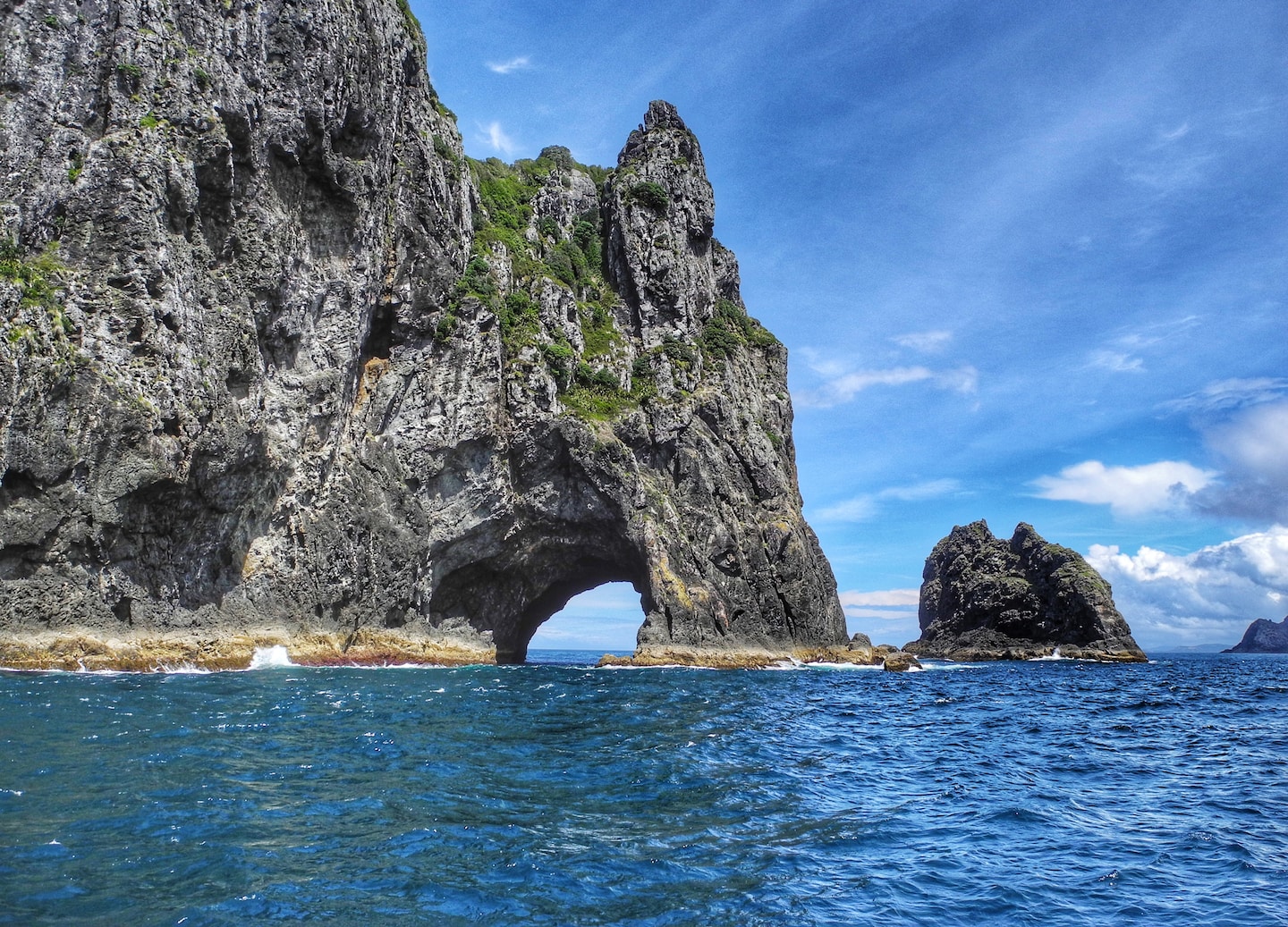 Cruise past Cape Brett to Motukōkako, the Hole in the Rock, with legends and dolphins. - Bay Of Islands, New Zealand