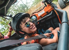 up close of boy riding passenger in utv