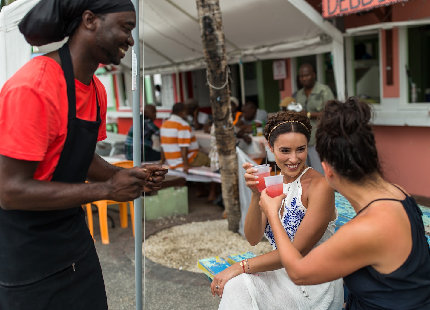 Cheers with local rum punch in Barbados — a spirited toast to love and celebration on island drive.
