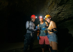 couple and guide inside cave