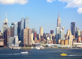 manhattan skyline with empire state building over hudson river new york city