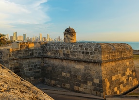 the san felipe fortress and the modern city of cartagena in the background with the caribbean sea