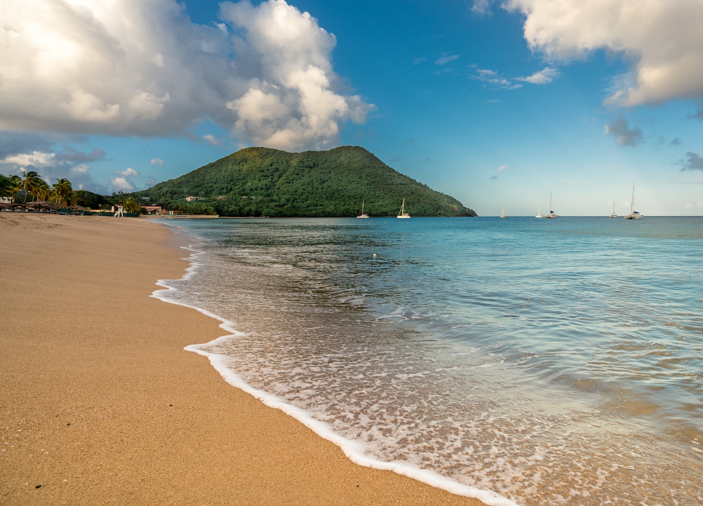 Sandy beach with gentle waves and mountains. - Castries, St. Lucia