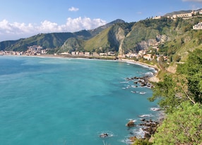 view of the bay and the beach of giardini naxos near taormina sicily