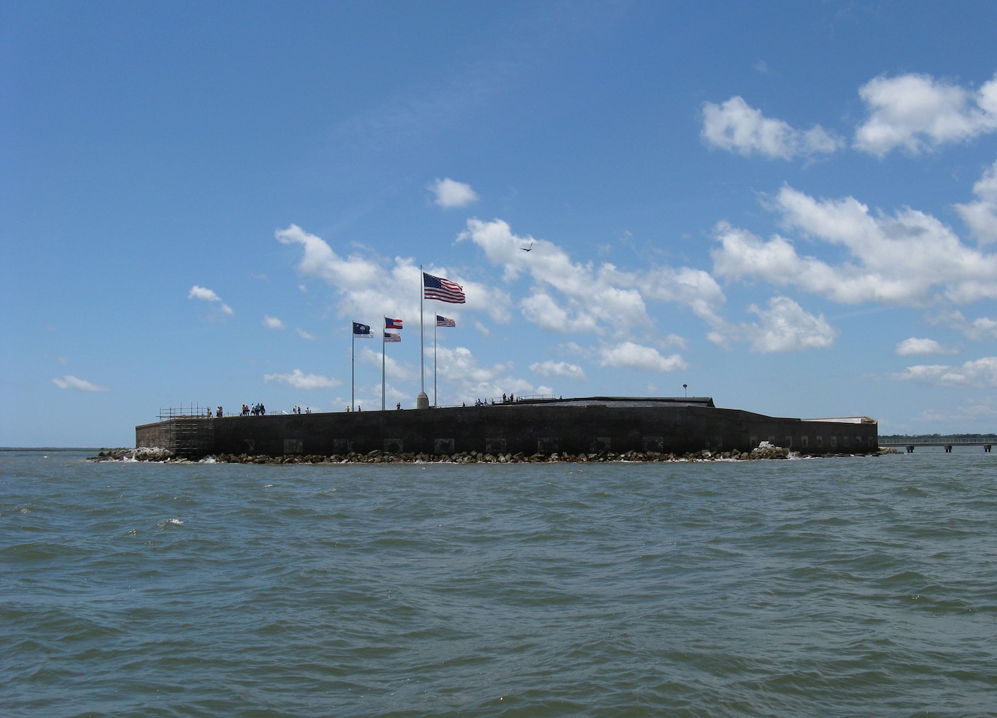 Historic Fort Sumter on water near Charleston harbor shoreline. - Charleston, South Carolina