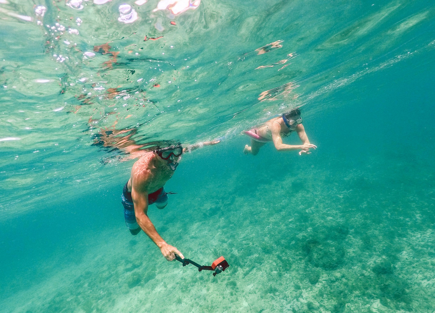 Man and woman snorkel together above clear Caribbean water near St. John’s Trunk Bay reef. - Charlotte Amalie, St. Thomas
