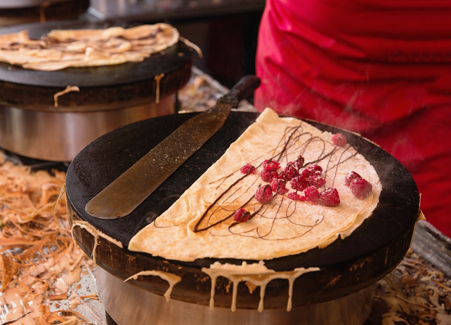 Golden crêpe cooks on hot griddle. - Cherbourg, France
