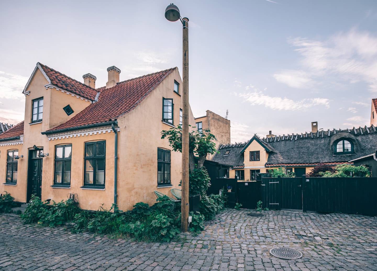 Colorful Copenhagen homes stand along a quiet street. - Copenhagen, Denmark