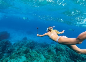 girl snorkel snorkeling in clear blue water