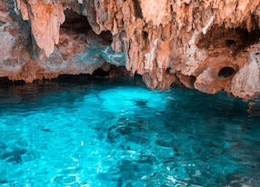 the crystal blue water in the rainbow cenote and orange cliffs chikin ha park in playa del carmen