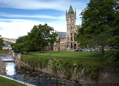 dunedin railway train station near river and park