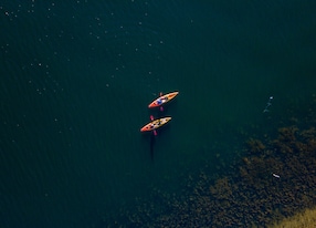 a pair of kayakers aerial drone photograph from above in dam queensland australia