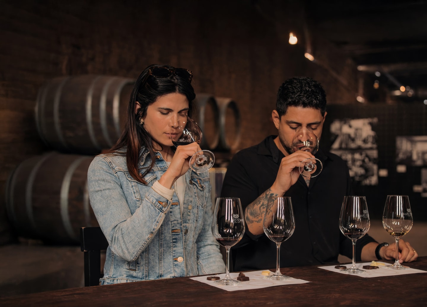 Wine glasses and chocolate pieces arranged for a tasting during a chocolate‑and‑wine experience. - Ensenada, Mexico
