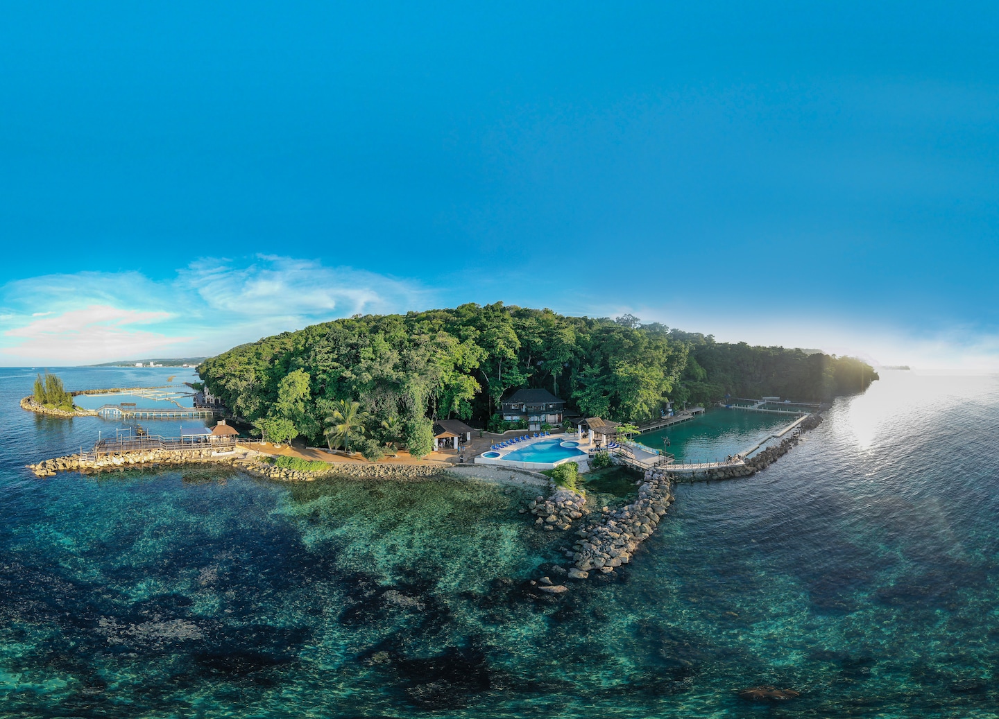 Aerial view shows dolphins swimming beside guests at Dolphin Cove. - Falmouth, Jamaica
