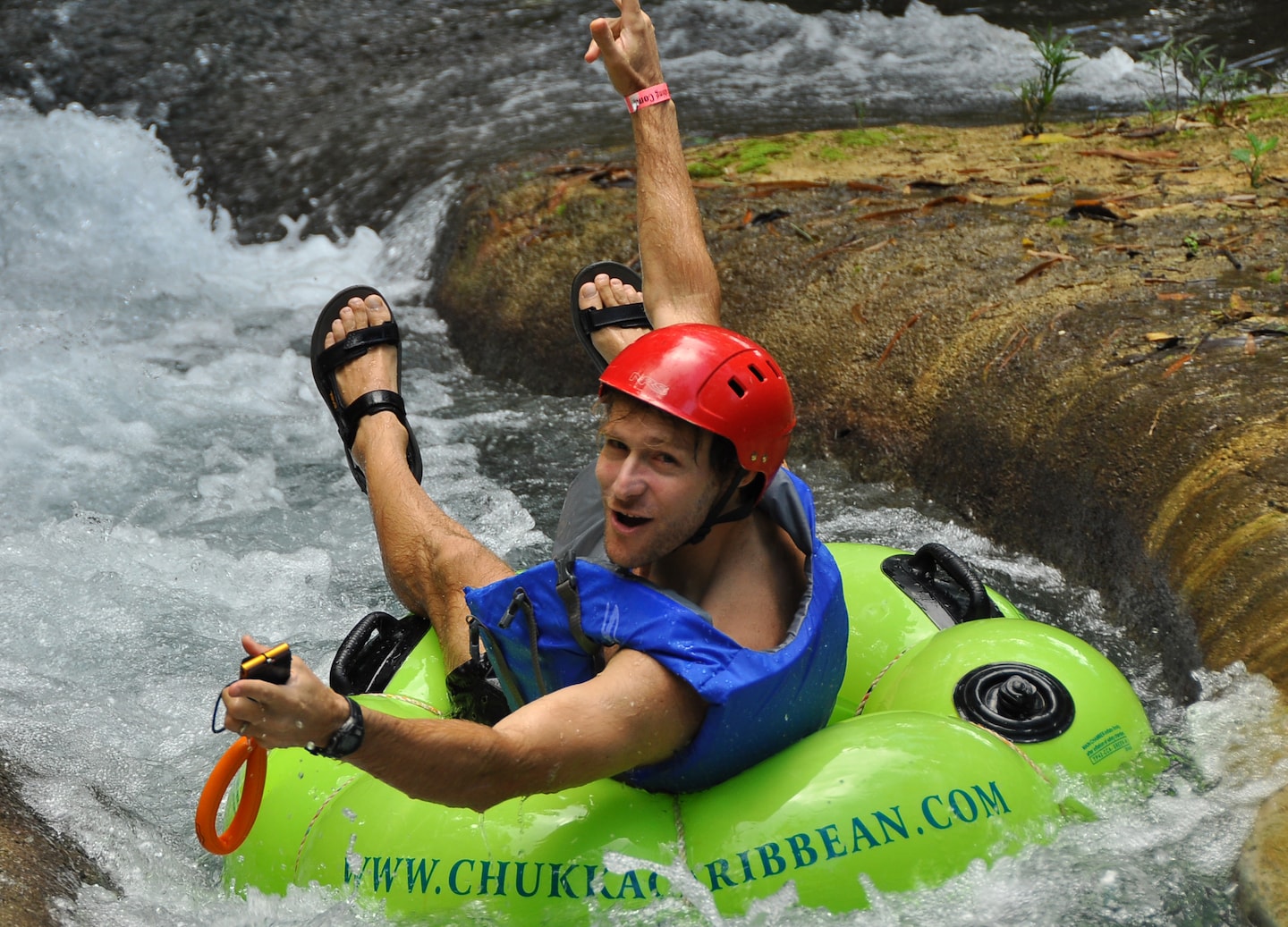 Guests tubing down a jungle river in Falmouth, Jamaica.