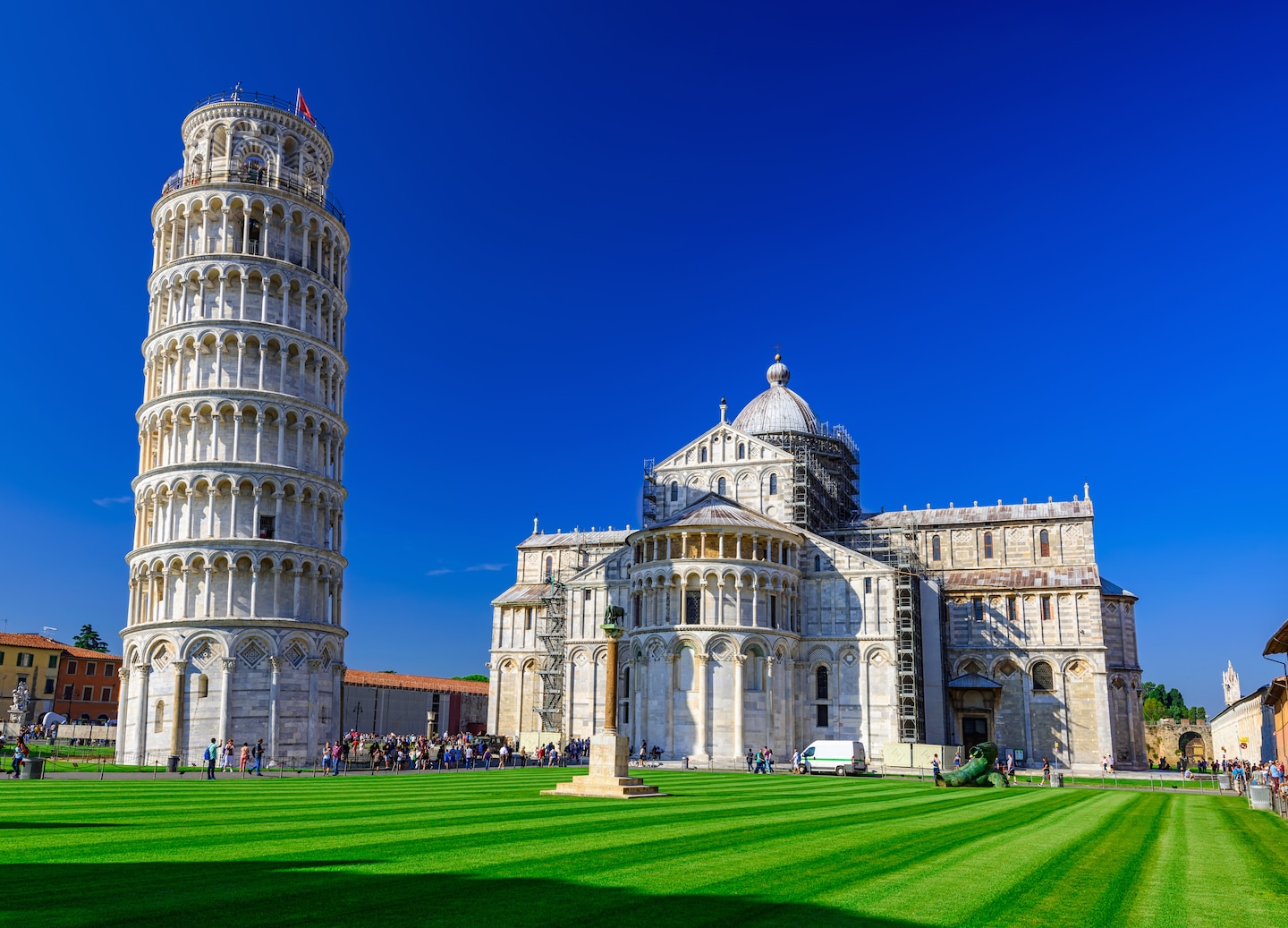 Pisa Cathedral and Leaning Tower rise above crowds under bright sunlight. - Florence / Pisa (La Spezia), Italy