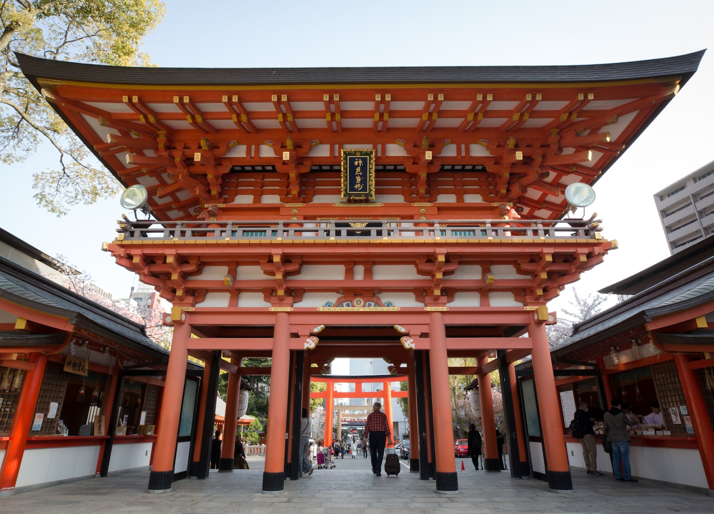 Dazaifu Tenmangu Shrine features ornate wooden architecture surrounded by lush greenery and a peaceful courtyard. - Fukuoka, Japan