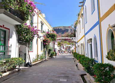 street with white houses colonia shown in puerto de mogan spain favorite vacation place for
