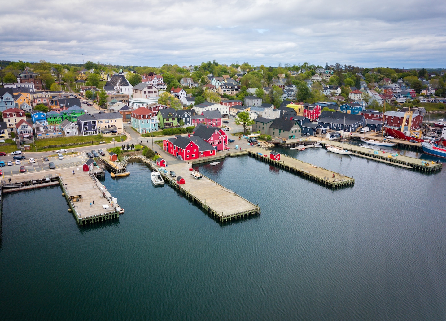 An aerial view of Halifax shows its waterfront piers, marina, and downtown buildings along the harbor. - Halifax, Nova Scotia