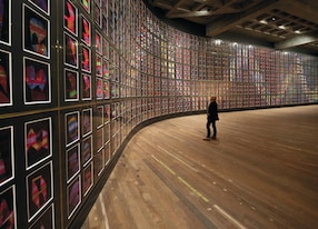 man viewing artwork on wall