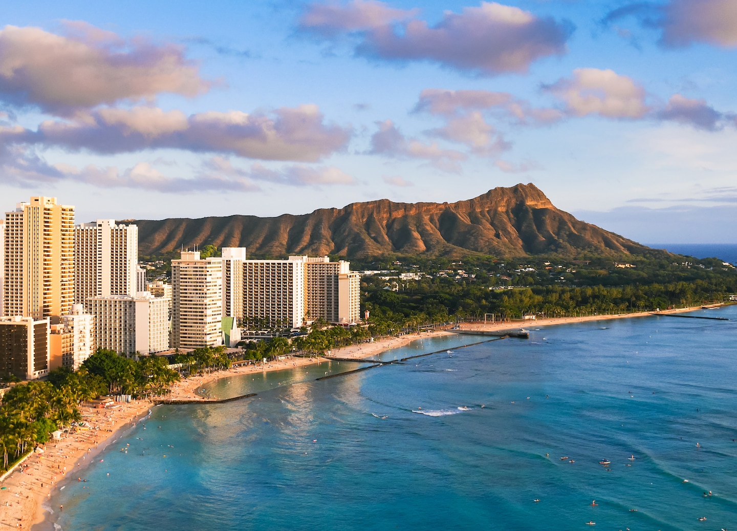 Waikiki Beach stretches toward Diamond Head, with hotels lining the shoreline beside calm blue water. - Honolulu, Oahu, Hawaii