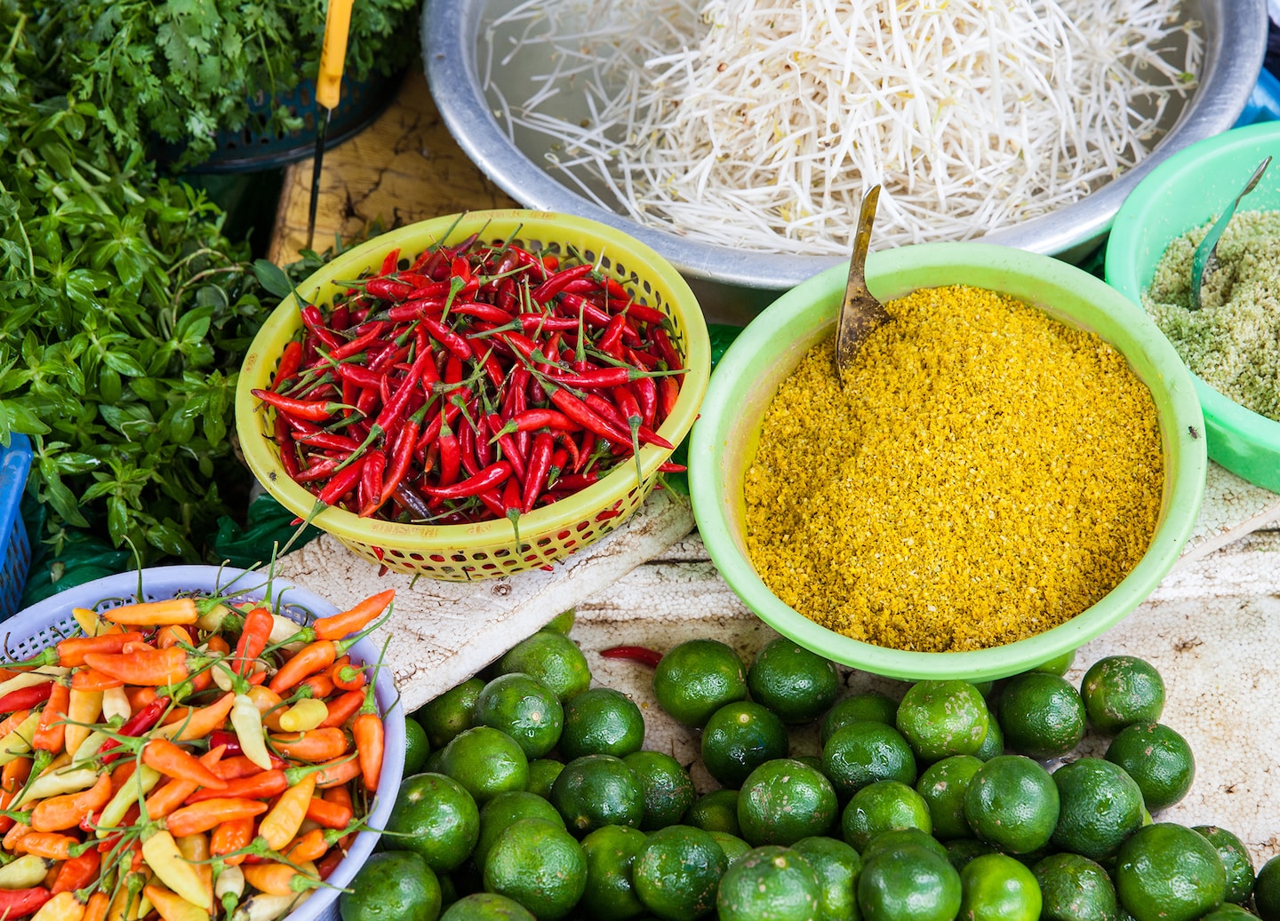 Colorful baskets filled with fresh vegetables, herbs, and vibrant spices for a cooking class in Ho Chi Minh.