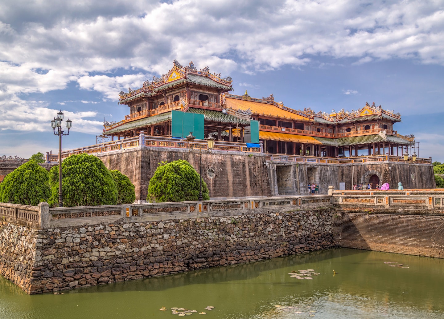 Imperial Hue’s citadel walls stretch across the river, showcasing Vietnam’s royal legacy. - Hue Imperial City, Vietnam