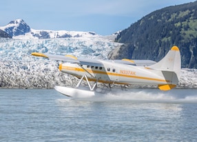 Taku Lodge Feast and 5 Glacier Seaplane plane in front of glacier