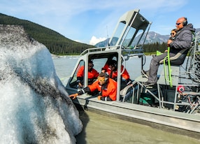 Taku Glacier Helicopter and Airboat Adventure Guest Touching Glacier