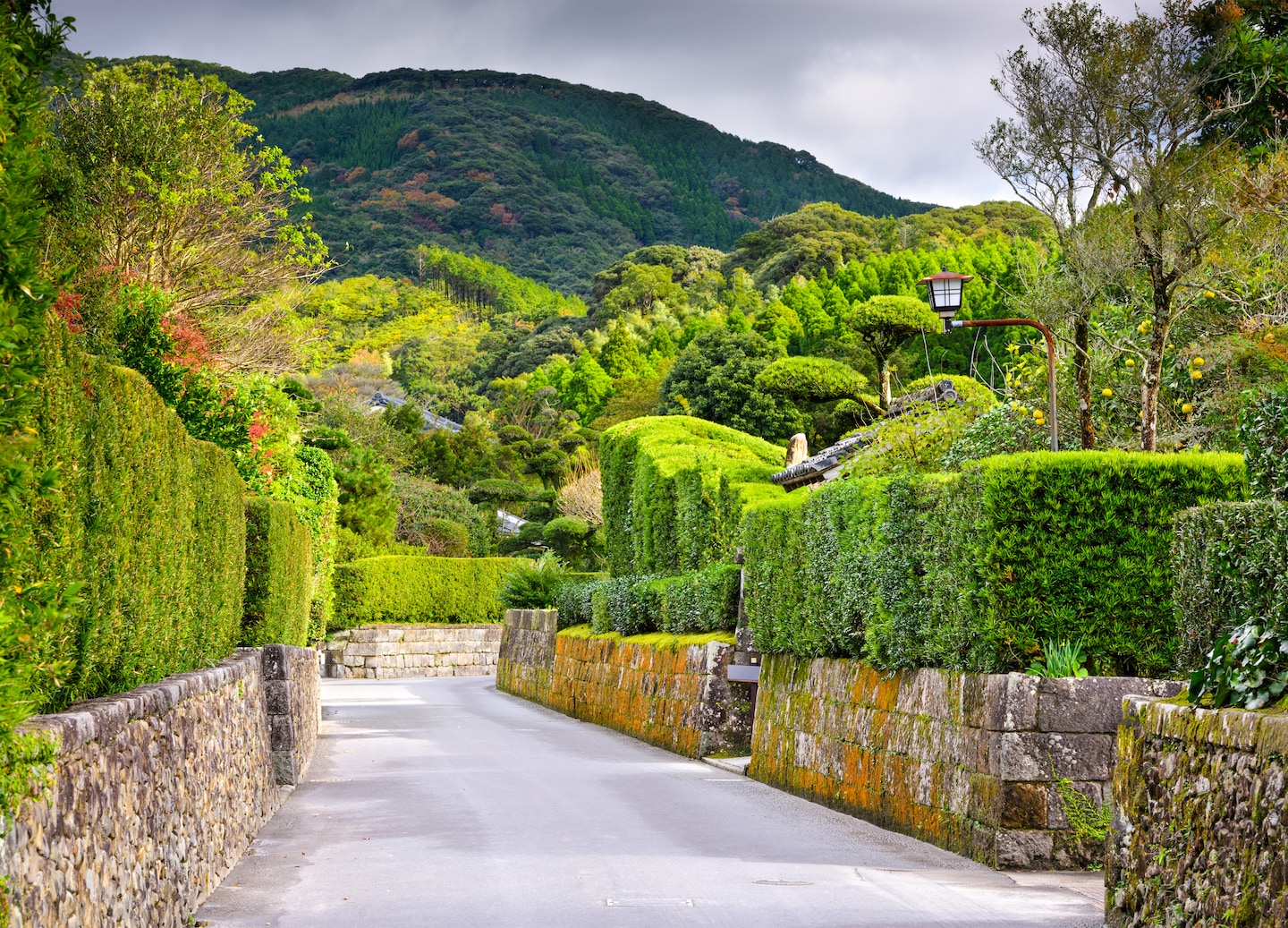 Traditional wooden homes line Chiran’s preserved samurai district, set along a quiet stone‑paved street. - Kagoshima, Japan