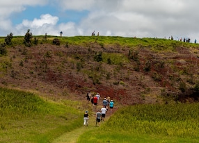 tourists hiking volcano national park hillside trail