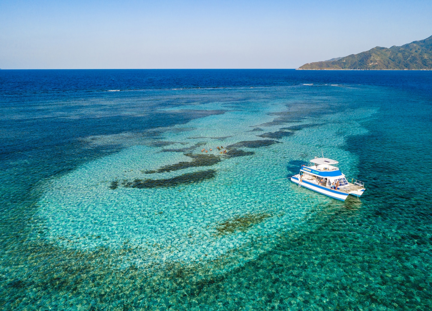 Sail Haiti’s scenic coast to a peaceful sandbar, enjoying drinks, sun, and exceptional service. - Labadee, Haiti