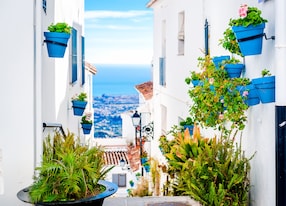 picturesque street of mijas with flower pots in facades andalusian white village costa del sol