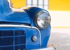 classic blue car against yellow wall nelson new zealand