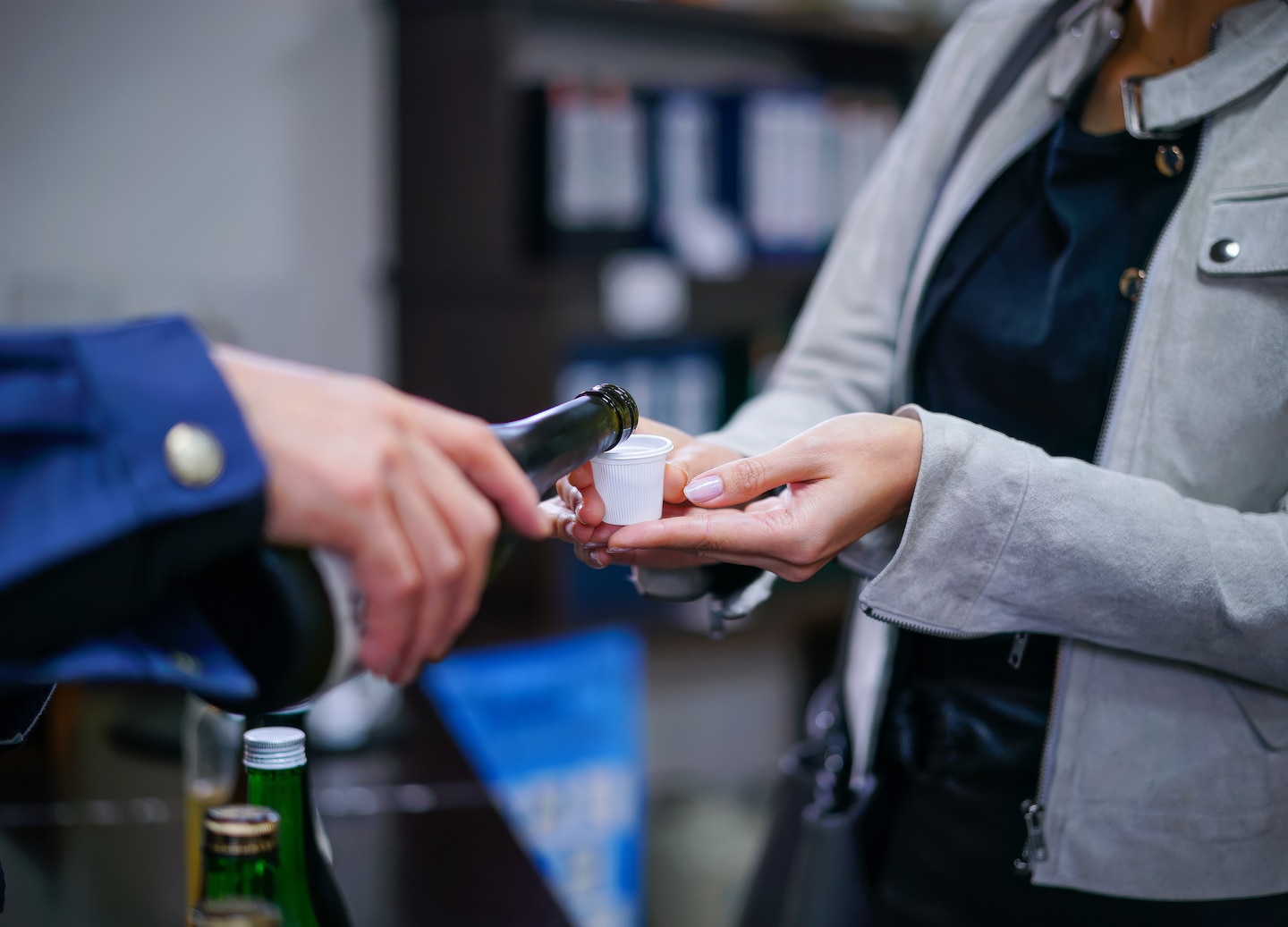 Fresh Niigata sake pours smoothly into cups, highlighting the region’s brewing tradition. - Niigata, Japan