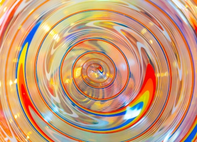 a piece of bright colorful glass with spiral structure