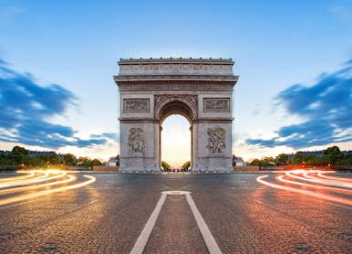 paris street at night with the arc de triomphe in paris france