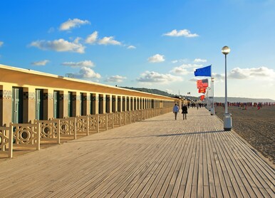 the famous boards of deauville on background of setting sun