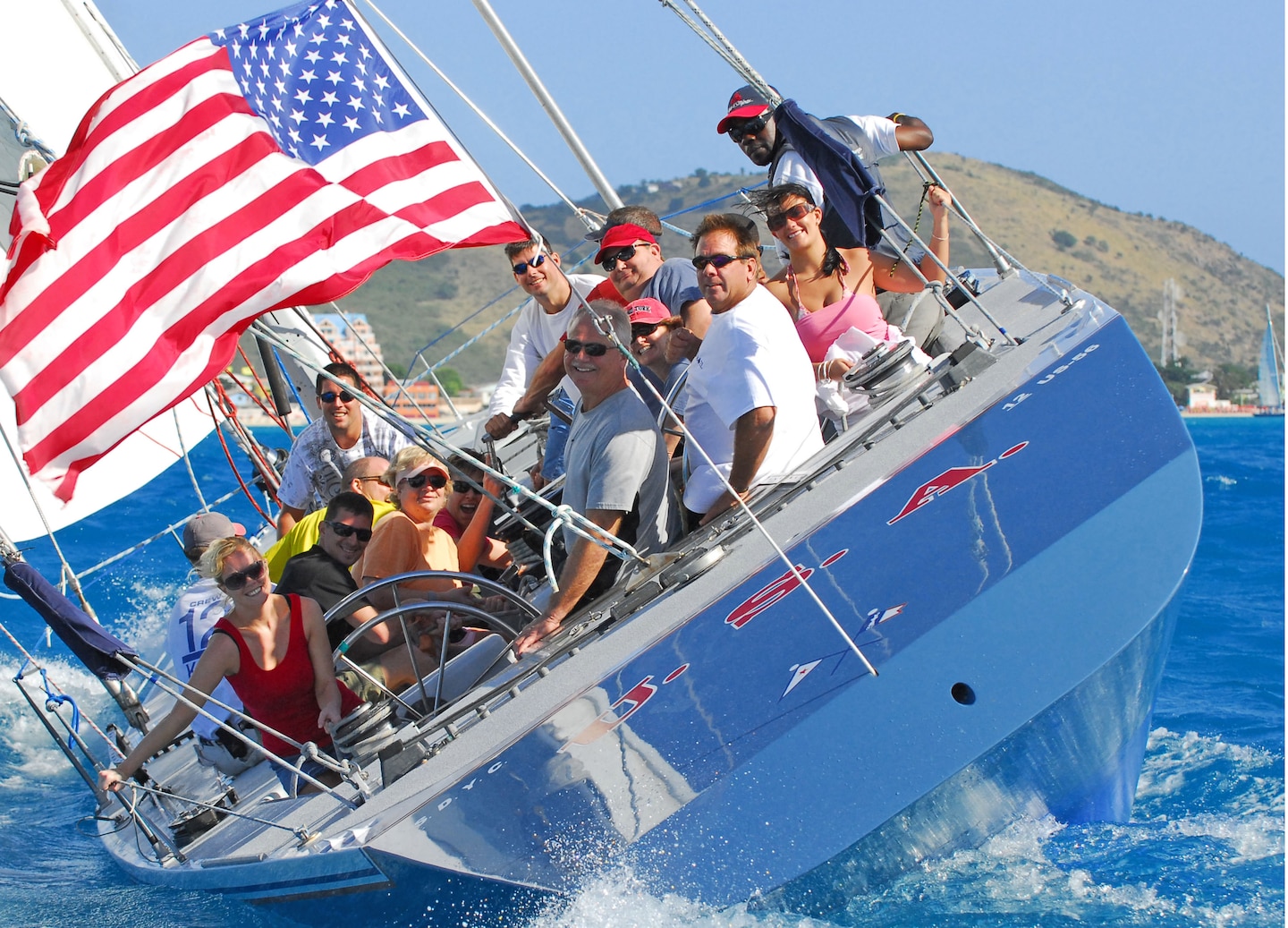 Sailboat cuts across bright Caribbean water, its sails full in the steady St. Maarten breeze. - Philipsburg, St. Maarten