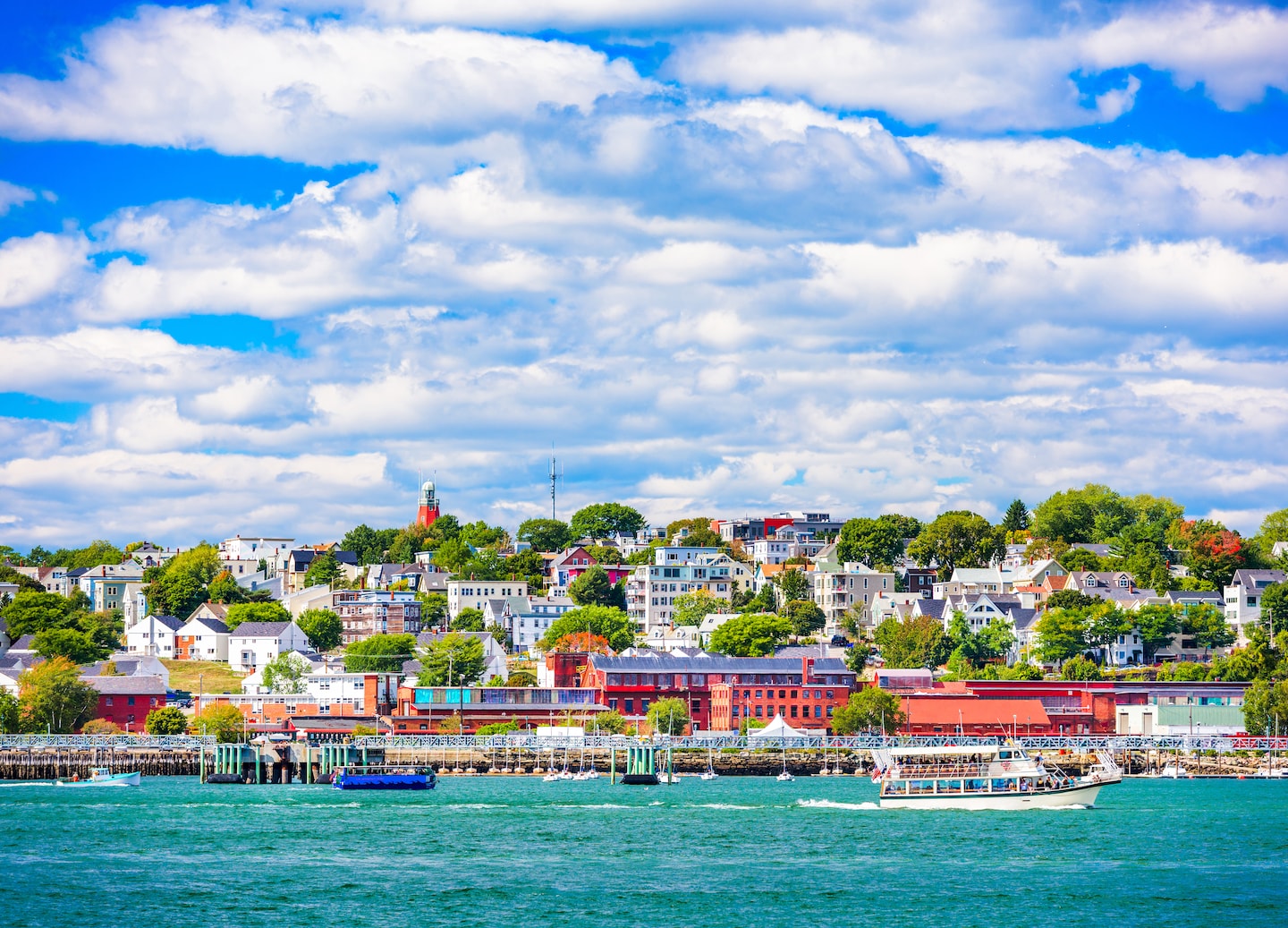 Portland’s coastal townscape shows colorful buildings along the waterfront with boats anchored in the harbor. - Portland, Maine