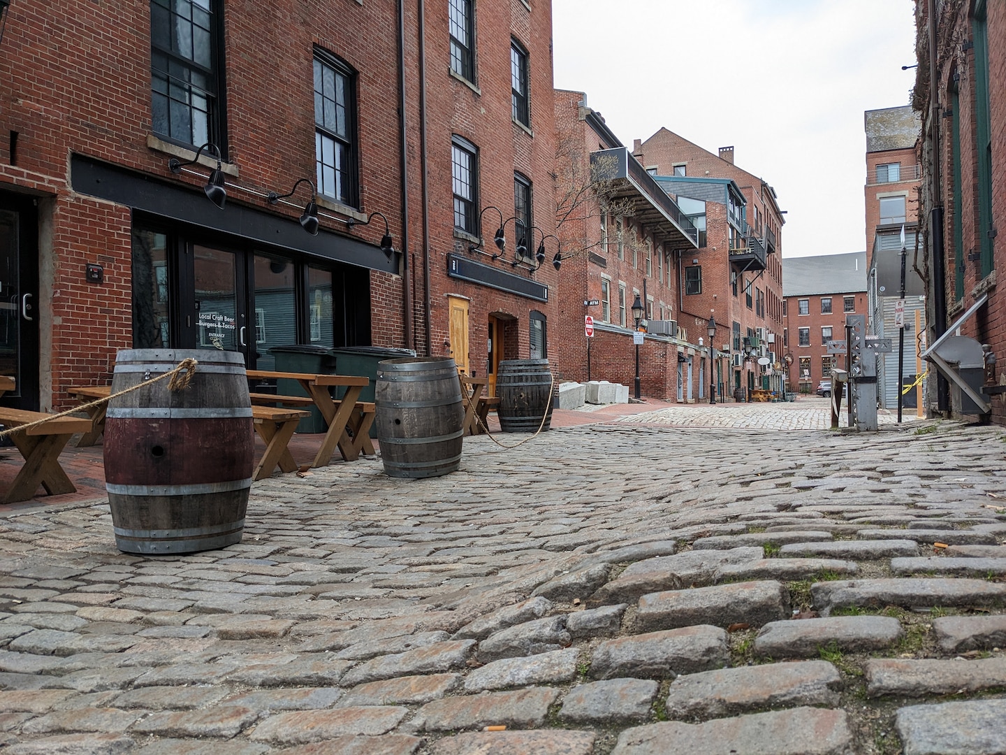A quiet Old Port street features brick buildings, cobblestones, and classic Portland coastal charm. - Portland, Maine