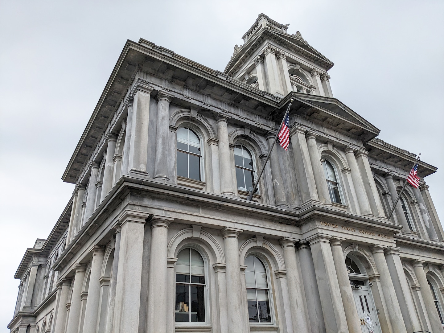 Portland’s U.S. Custom House stands tall with ornate stonework overlooking the historic Old Port. - Portland, Maine